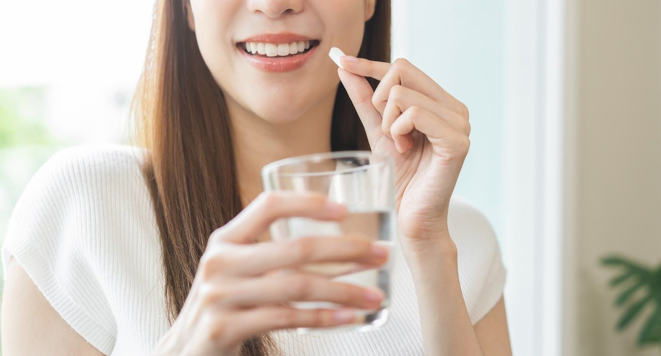 mulher tomando suplemento para cabelo